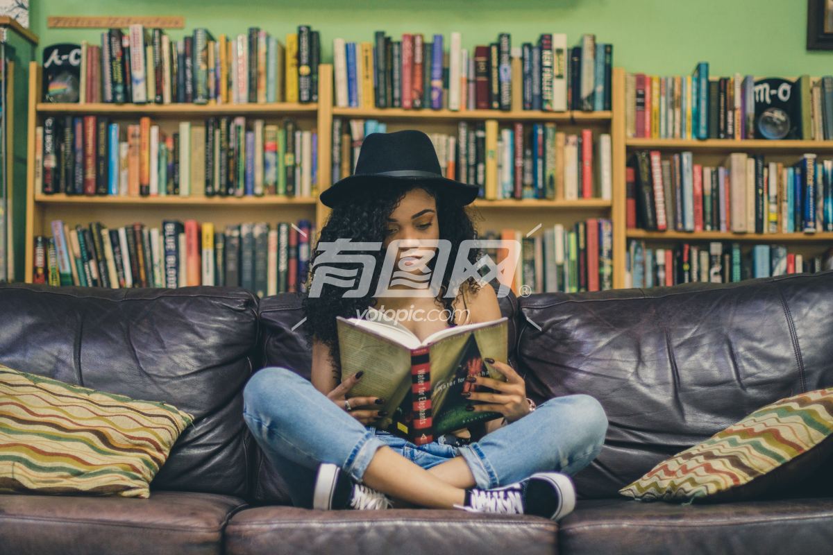 坐在沙发上阅读的女孩